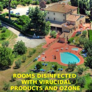 an aerial view of a house with a swimming pool at Hotel Residence Villa Rioddi in Volterra