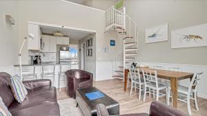a living room and kitchen with a table and chairs at Windward Shores in Amagansett