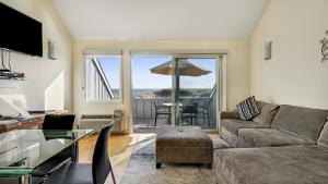 a living room with a couch and a glass table at Windward Shores in Amagansett