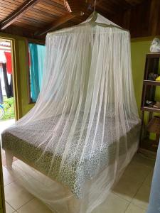
a bed that has a canopy over it at Bungalows Kire in Puerto Viejo

