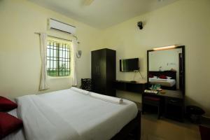 Postel nebo postele na pokoji v ubytování Srichand Business Class Rooms