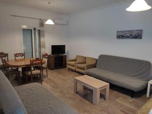 a living room with a couch and a table at Steve Apartments in Áno Garoúna