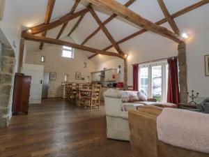 a large living room with wooden beams and a kitchen at Main Barn in Saltburn-by-the-Sea