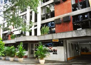 a building with potted plants in front of it at Hotel Xanadu - Adults Only in Rio de Janeiro