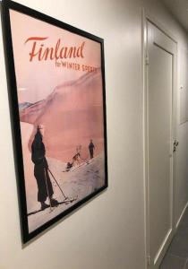 a poster of a man on skis on a wall at Ski Studio Levi in Levi