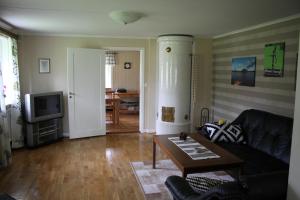 a living room with a couch and a table at Flahult Holiday Home in Hok