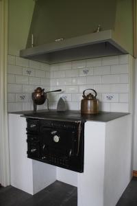 a stove with two tea pots on top of it at Flahult Holiday Home in Hok