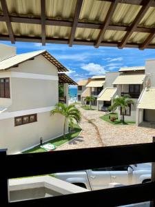 a view from a window of a building with palm trees at CASA BEIRA MAR NA BARRA DE SÃO MIGUEL in Barra de São Miguel