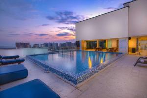 a large swimming pool on the roof of a building at GHL Hotel Barranquilla in Barranquilla