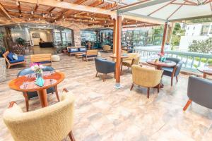 a restaurant with tables and chairs on a patio at Sonesta Hotel Loja in Loja