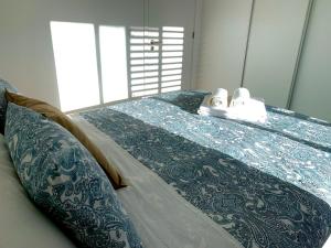 a bed with towels and slippers on top of it at L'Azor Suites - Bleuté in Ponta Delgada