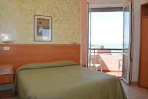 Postel nebo postele na pokoji v ubytování Hotel Cristina
