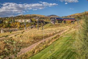 a train on a track on a hill with a city at Bear Claw 514 - Bear Claw II Building in Steamboat Springs