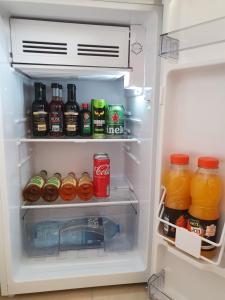 an open refrigerator filled with lots of drinks and beverages at Top Secret in Arandelovac