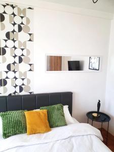 a bedroom with a bed with green and yellow pillows at Top Secret in Arandjelovac