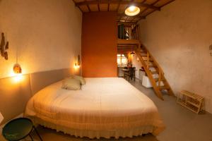 a bedroom with a large bed and a staircase at Vila do Lago in São Bento do Sapucaí