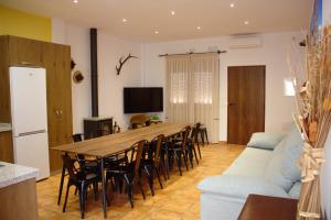 una sala de estar con una mesa larga y sillas en Casa Rural Sierra de las Nieves, en Yunquera