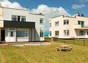 a house with a picnic table in front of it at SEA VIEW - First Floor 3 bed apartment looking over Bridlington North Beach in Bridlington