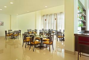 a large dining room with tables and chairs at Ginger Gondia, Balaghat Road in Gondia