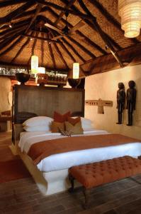 a bedroom with a large bed in a room at Mahua Kothi Bandhavgarh - A Taj Safari Lodge in Tāla