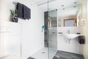 a bathroom with a glass shower and a sink at Köcks Bed & Breakfast in Galtür +5 photos