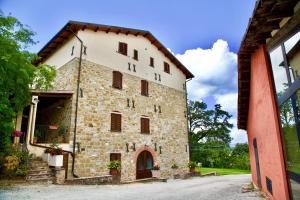 a large stone building with aventh floor at Faro Rosso in Montanaldo