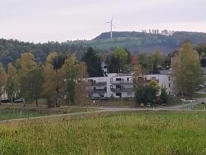 a building with a wind turbine in the background at Monteursunterkunft Talblick in Lügde