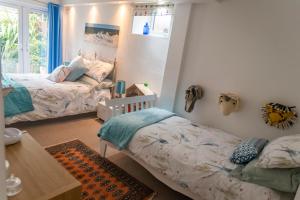 a bedroom with two twin beds and a table at The Old Bakery in Cromer