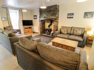 a living room with two couches and a fireplace at Halford Hill in Llanberis