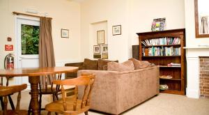 a living room with a couch and a table at YHA Streatley on Thames in Streatley