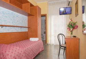 En eller flere senge i et værelse på Hotel Colibri B&B