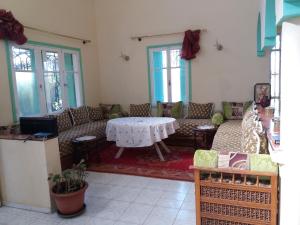 a living room with couches and a table at villa waresa in Derroua
