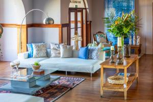 a living room with a white couch and a table at Hotel San Marcos Punta del Este in Punta del Este
