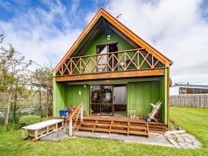 a green tiny house with a porch and a deck at Green Gables Raetihi - Ohakune Holiday Home in Raetihi