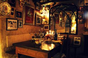 a dining room with a table in a room with pictures at Hotel La Posada de Lalola in Buera