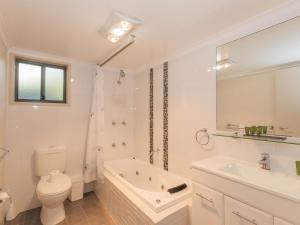 Un baño blanco con inodoro y lavabo. en Boronia 7 30 Nettin Circuit, en Jindabyne 12 fotos más