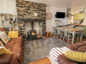 a living room with a couch and a fireplace at Snowdon View in Caernarfon