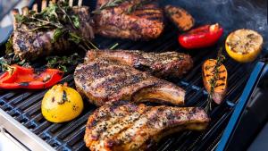a bunch of meat and vegetables on a grill at Beach Side Secret in Ginoza