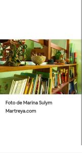 a book shelf filled with lots of books at Jardín de Naipí in Puerto Iguazú