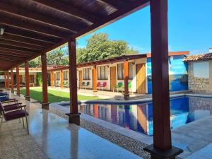 a view of the courtyard of a house with a swimming pool at Hotel La Siesta in Liberia