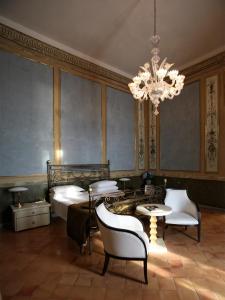 a bedroom with a bed and a chandelier at Miglio d'Oro Park Hotel in Ercolano