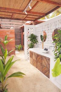 a bathroom with a counter in a room with plants at Vista Mare Beach House in Tierra Bomba