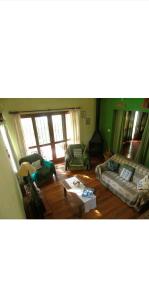 a living room with two couches and a table at Jardín de Naipí 2 in Puerto Iguazú
