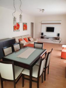 a dining room table and chairs in a living room at Casa Golfo Nuevo in Puerto Madryn