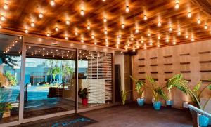 a patio with lights hanging from a wooden ceiling at Hotel La Croix in Honolulu