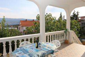 a table and chairs on a balcony with a view at Apartments Nadenic in Šilo