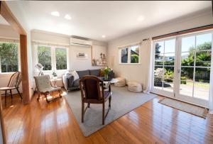 a living room with a couch and a table at The Coastal Casa ~ Close to the beach and town in Mount Maunganui