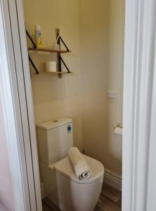 a bathroom with a toilet with a towel on it at The Heart of Hastings in Hastings