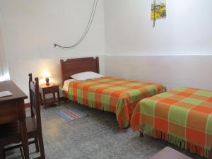 Postel nebo postele na pokoji v ubytování Hostal La Cazihita