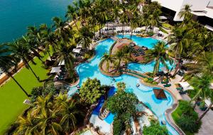 an aerial view of a resort pool with palm trees at Sofitel Philippine Plaza Manila in Manila